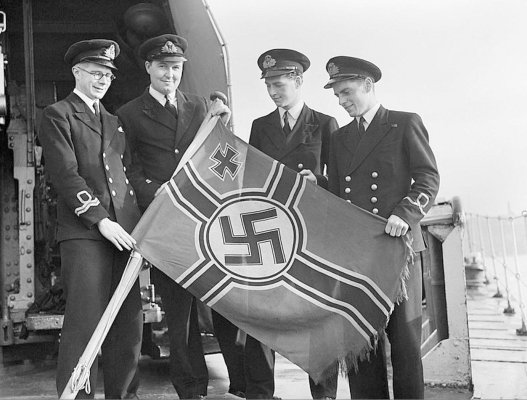 791px-Royal_Navy_officers_aboard_the_destroyer_HMS_GARTH_with_a_captured_German_E-boat_ensign_at.jpg