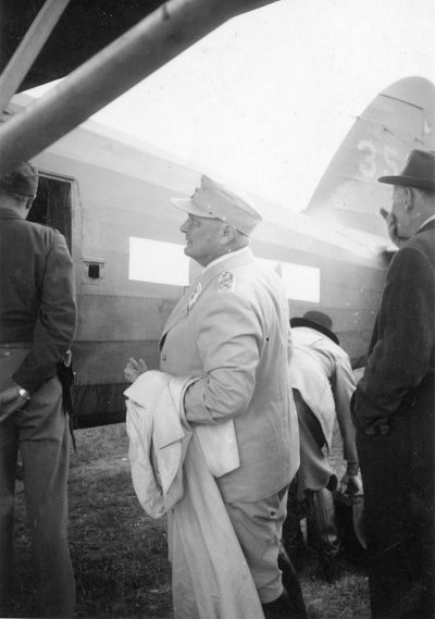5. Hermann Goering waits to board the plane to Camp Ashcan, a temporary prisoner-of-war camp in .jpg