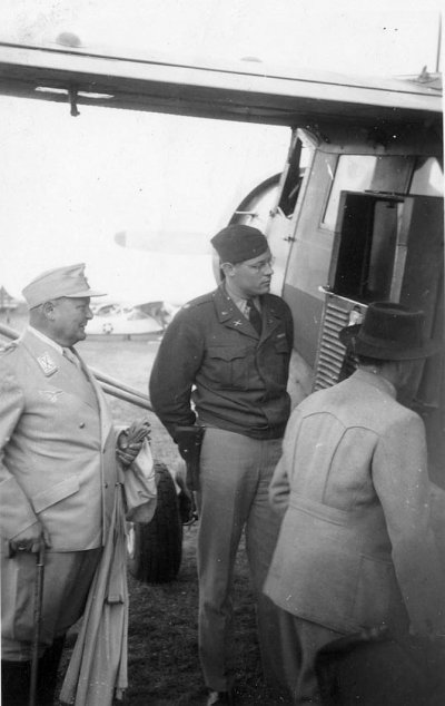 Hermann Goering waits to board the plane to Camp Ashcan, a temporary prisoner-of-war camp housed.jpg