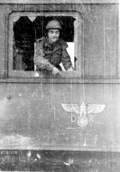 Sergeant Albert Lipschultz standing inside of a captured German railcar. Lipschultz stands in a .jpg